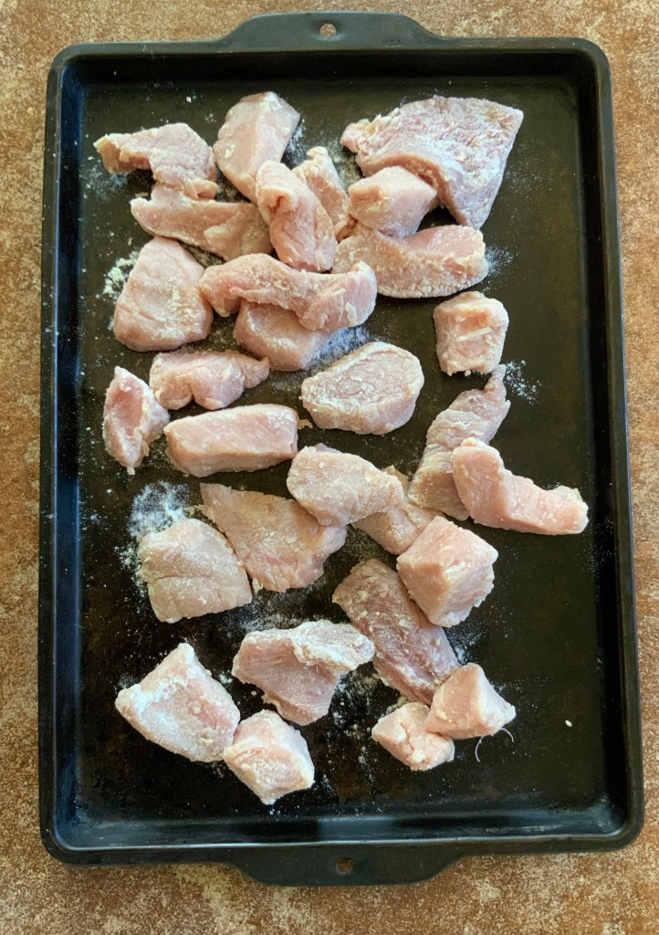 Pork loin cut and floured for carbonnade...can use tenderloin instead
